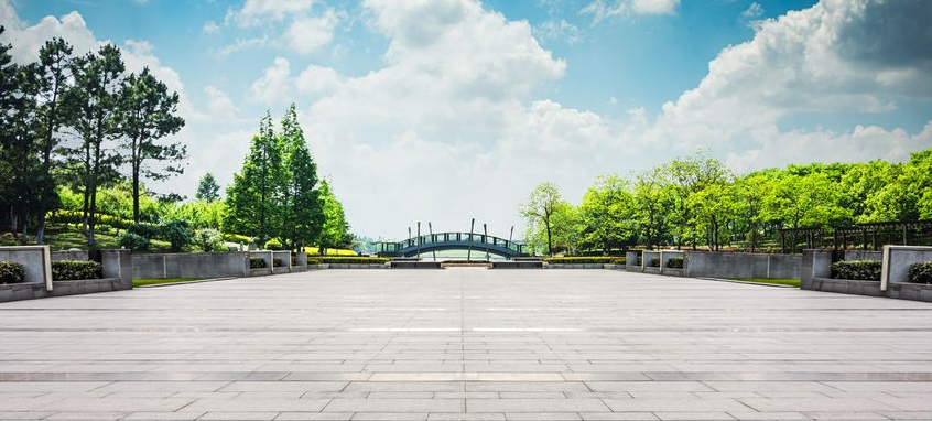 Image of Road leading to bridge with blue sky and white clouds