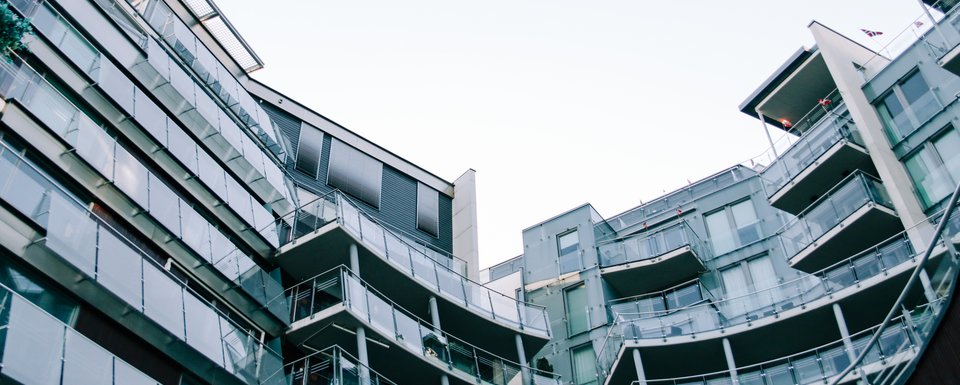 Modern geometric glass building with balconies