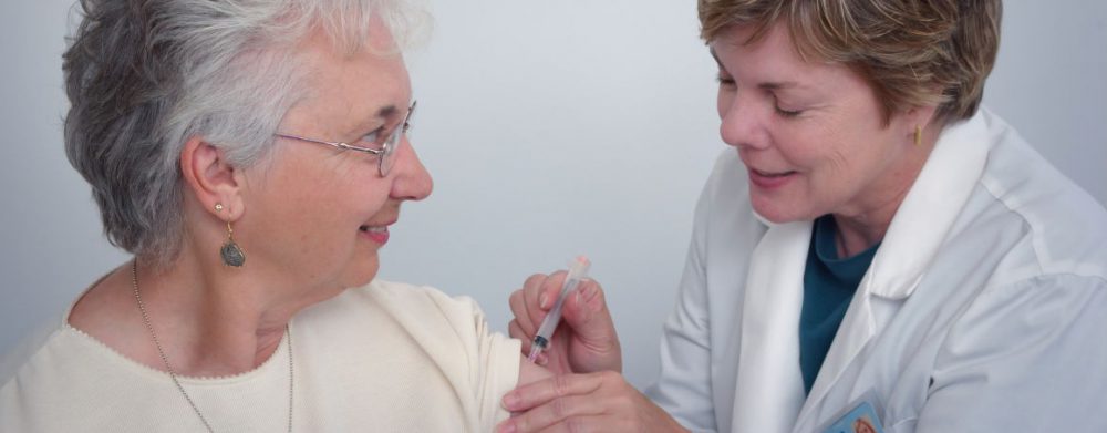 A patient being administered a vaccine by a doctor