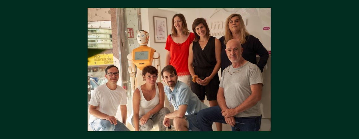 Image of ARI robot with a group of healthcare workers and researchers at pilot site