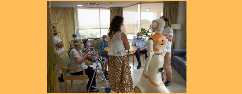 Photo of a group of elderly gathered around a PAL robot